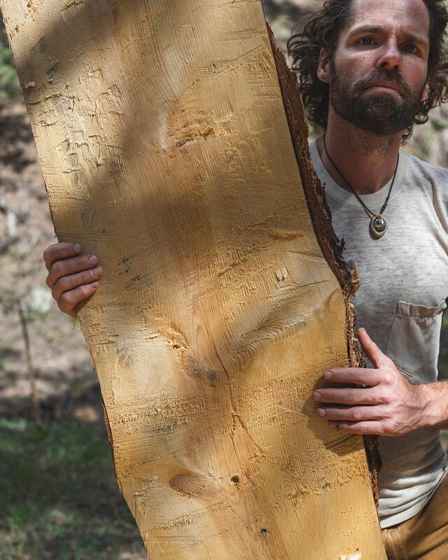 Boulder county propery owner Ryan O’Malley with a pine board from his 35 forested acres.