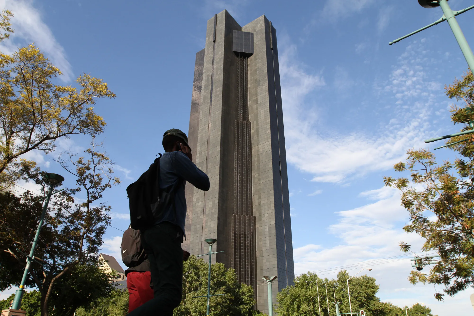 Pedestrians pass the headquarters of the South African Reserve Bank in Pretoria, South Africa.
