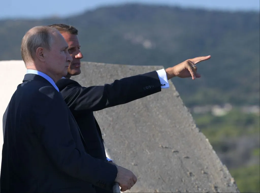 Vladimir Putin is awaiting hints from Emmanuel Macron.