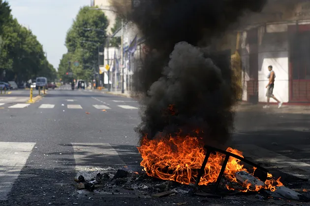 Juan B. Justo Avenue in Buenos Aires is blocked with trash and a bonfire during a protest by people affected by power outages on Dec. 30