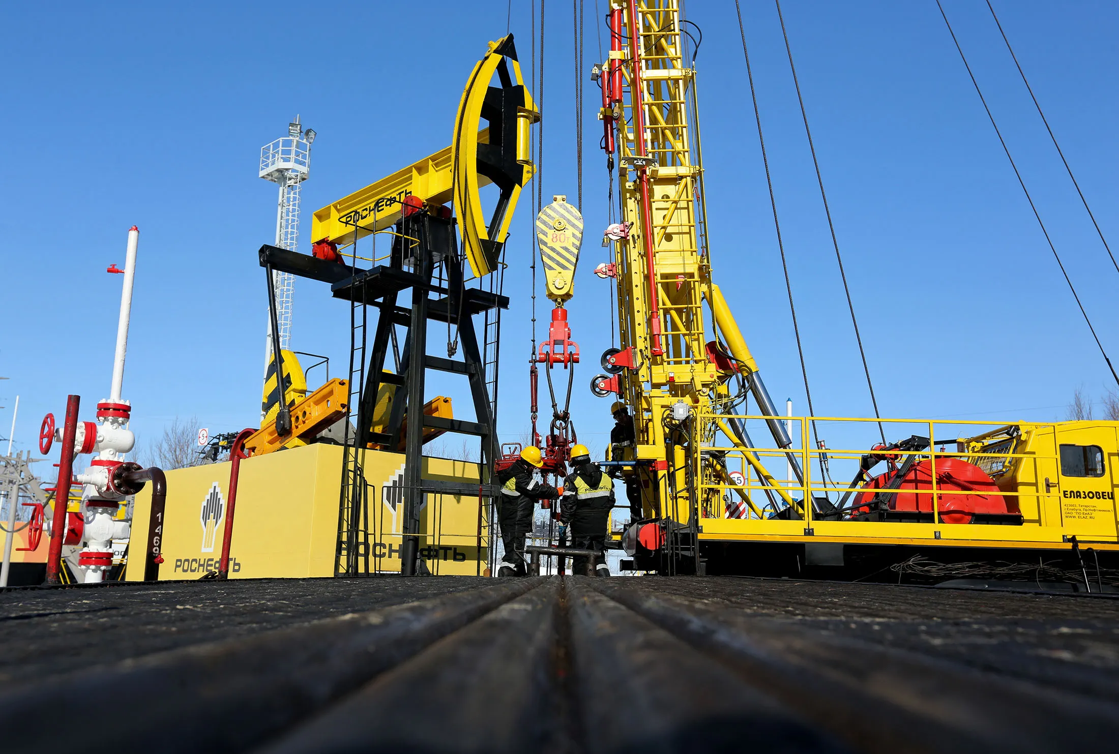 Workers perform a well-workover operation at a multiple well platform&nbsp;in the Samotlor oilfield near Nizhnevartovsk, Russia.