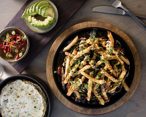 Llama Inn's deluxe lomo saltado, a Peruvian beef stir-fry, includes pancakes and fixings so you can fold your own tacos.
