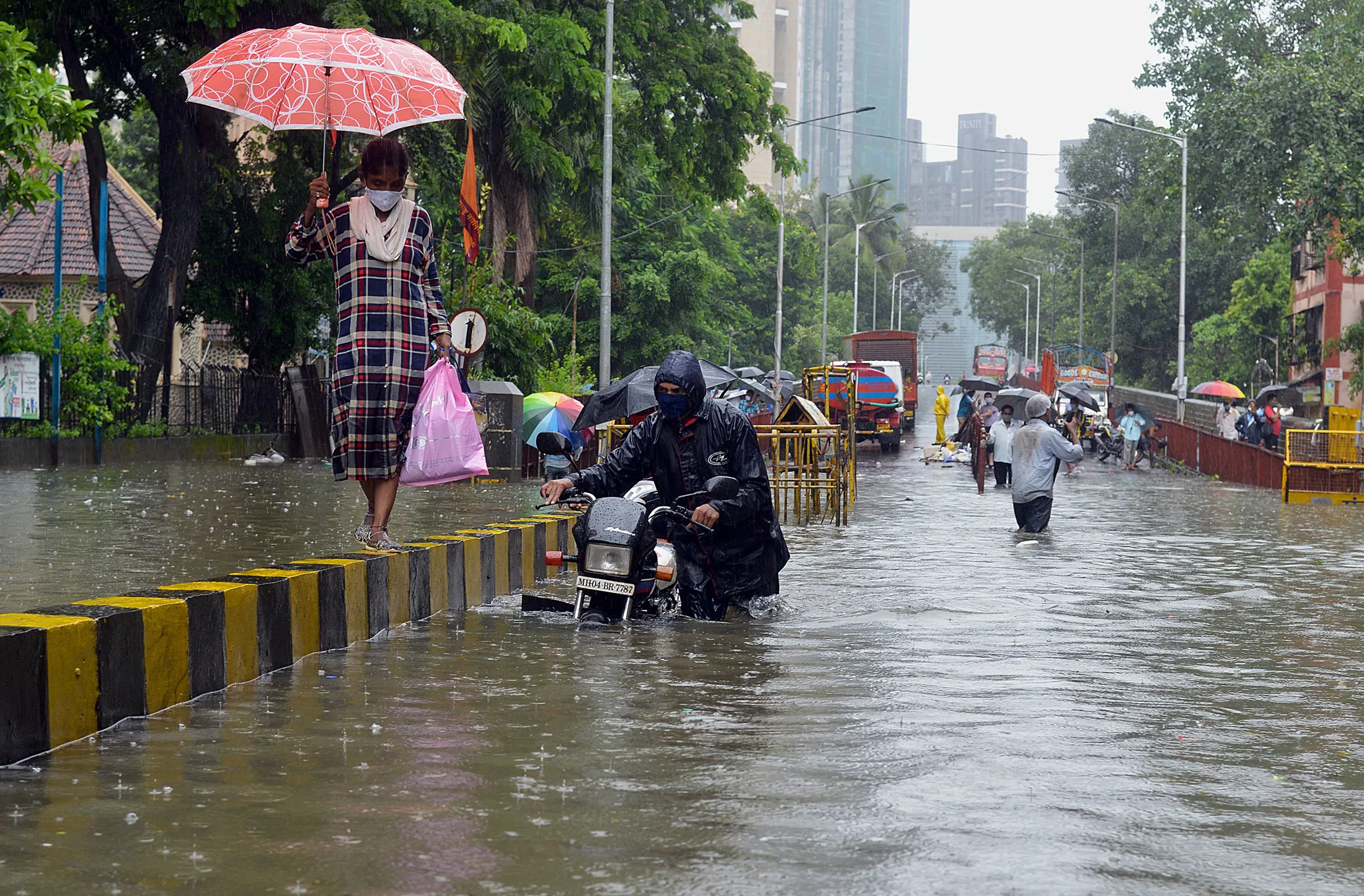 A motorist pushes his stalled bike during a heavy monsoon rainfall in Mumbai on Aug. 4.