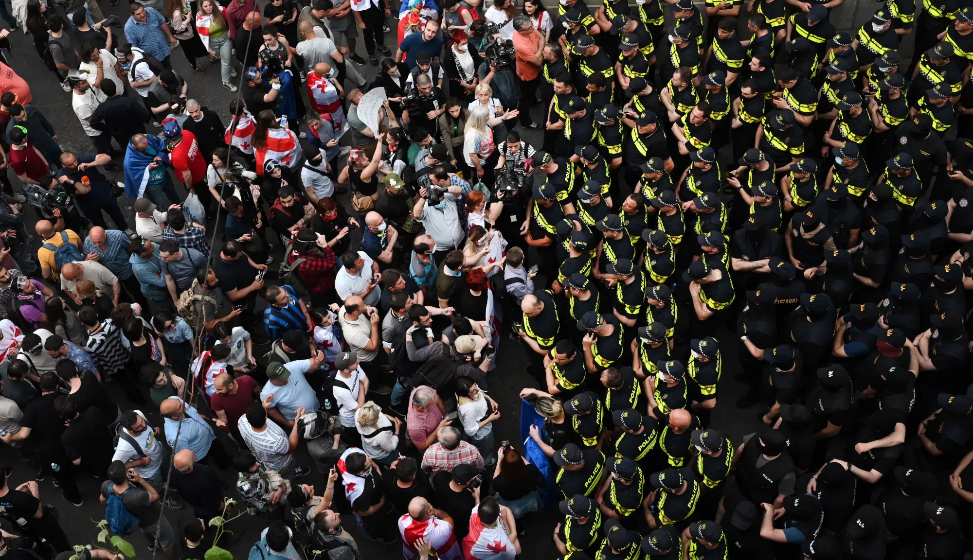 Demonstrators face police officers outside the Georgian parliament&nbsp;in Tbilisi on May 1.&nbsp;