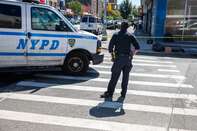 An NYPD officer monitors a crime scene in the Brooklyn borough of New York.
