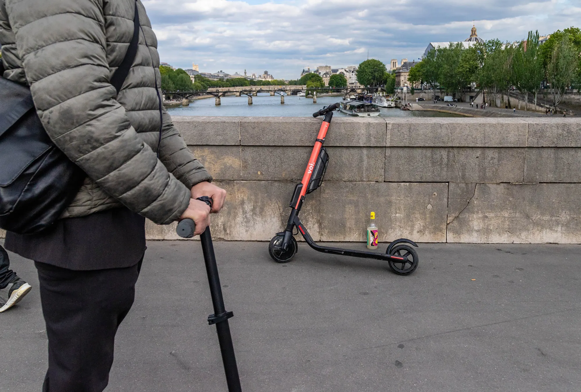 A Voi Technology public hire e-scooter&nbsp;on a bridge over the River Seine in Paris.