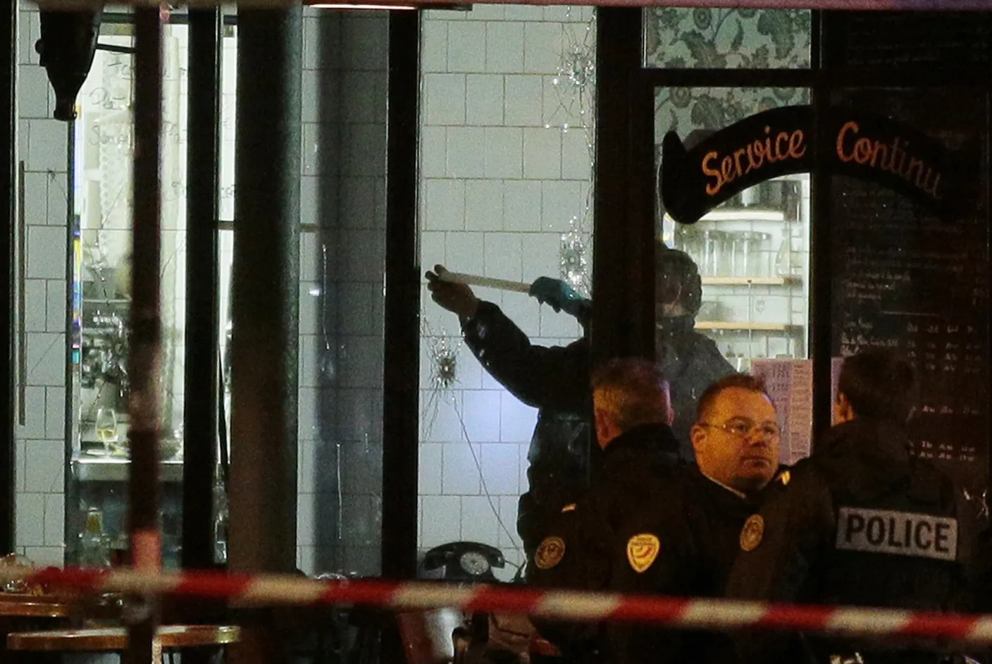 Forensic police search for evidences inside the La Belle Equipe cafe, rue de Charonne, at the site of an attack in Paris on Saturday, Nov. 14, 2015.

