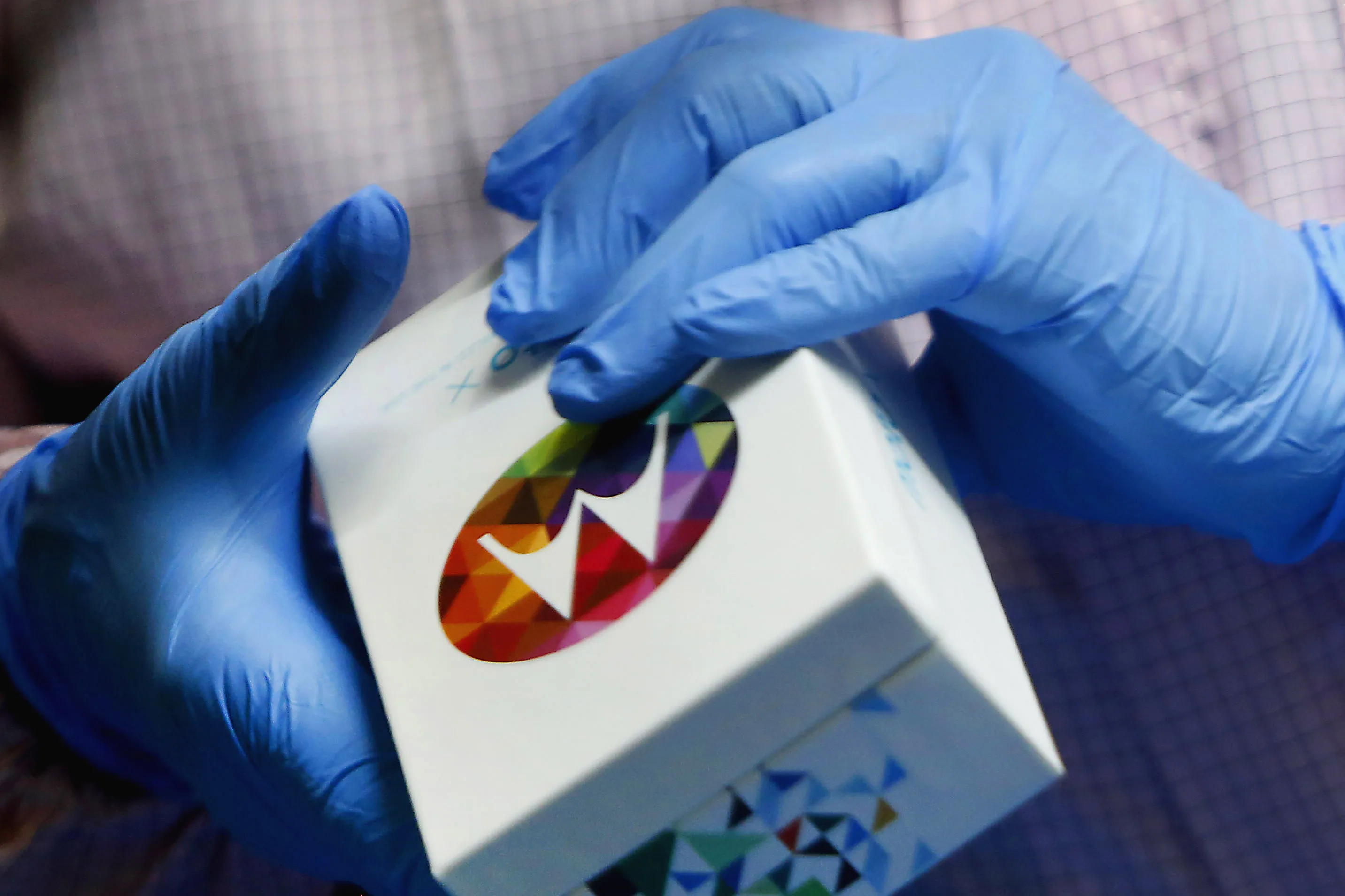 An employee holds the box of Motorola Mobility's Moto X smartphone at the Flextronics International Ltd. factory in Fort Worth, Texas. Photographer: Mike Fuentes/Bloomberg