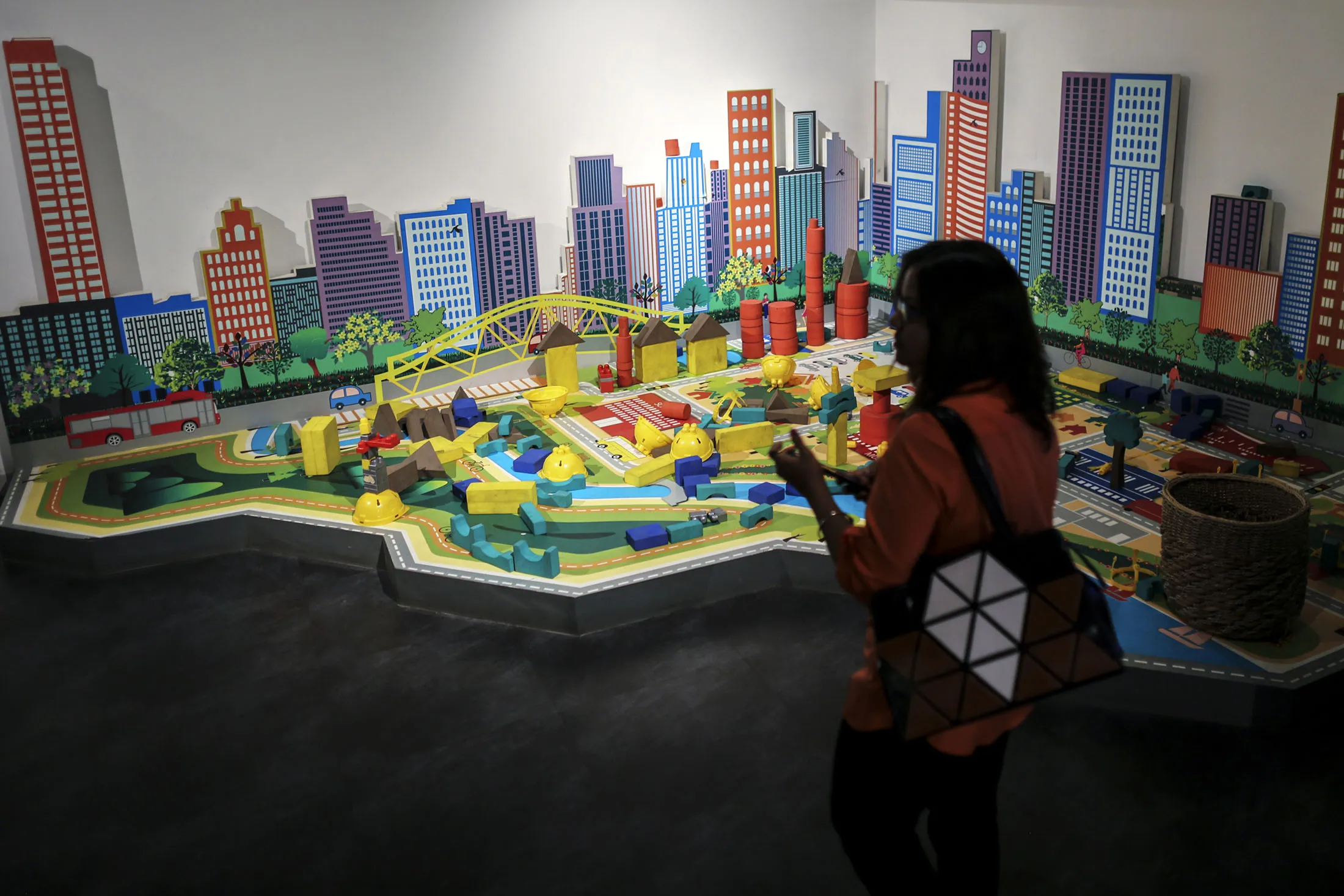 A woman walks near a model in a Lodha Group showroom in Palava City on the outskirts of Mumbai, India, on Thursday, May 25, 2017.
