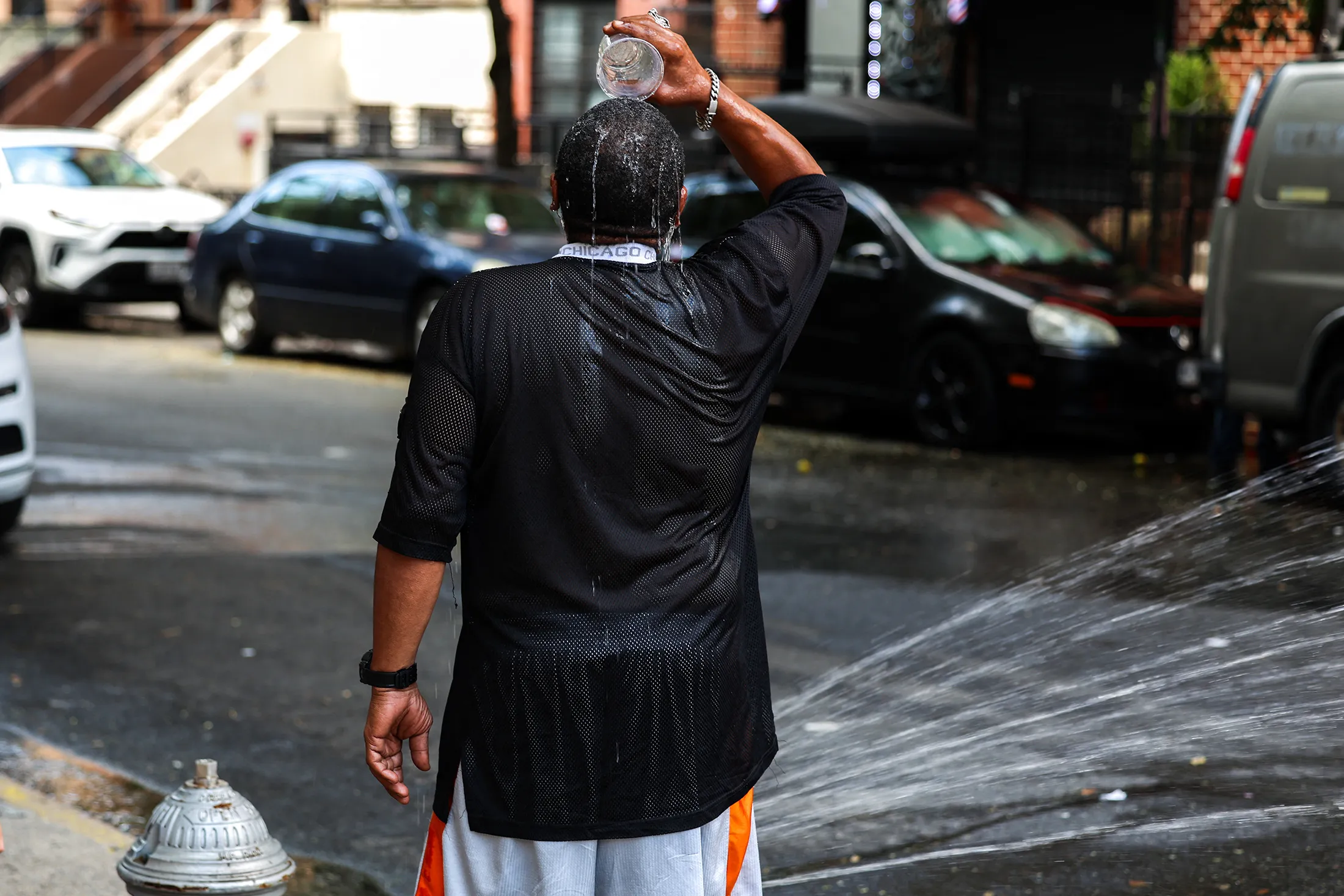 A resident cools off with fire hydrant water in the Hamilton Heights neighborhood of New York on July 25.