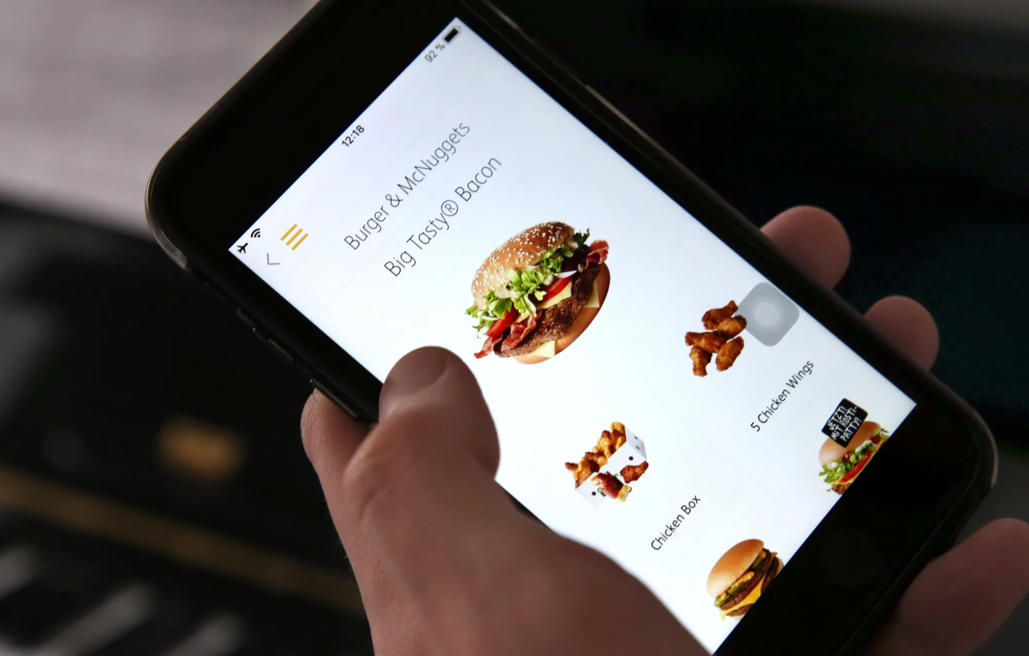 The fast food chain McDonald's app on the screen of a smartphone.