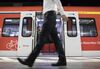 A city worker passes a Deutsche Bahn underground train as it stands at a platform during the morning rush hour commute at Taunusanlage S-Bahn underground railway station in Frankfurt, Germany, on Monday, Aug. 7, 2017. London could lose 10,000 banking jobs and 20,000 roles in financial services as clients move 1.8 trillion euros ($2.1 trillion) of assets out of the U.K. on Brexit, according to think-tank Bruegel.