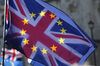 Sunlight shines through a Union flag, also known as Union Jack, adorned with the stars of the European Union (EU).