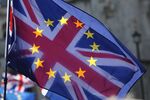Sunlight shines through a Union flag, also known as Union Jack, adorned with the stars of the European Union (EU).