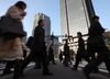 Morning commuters make their way to work in the central business district of Tokyo, Japan,