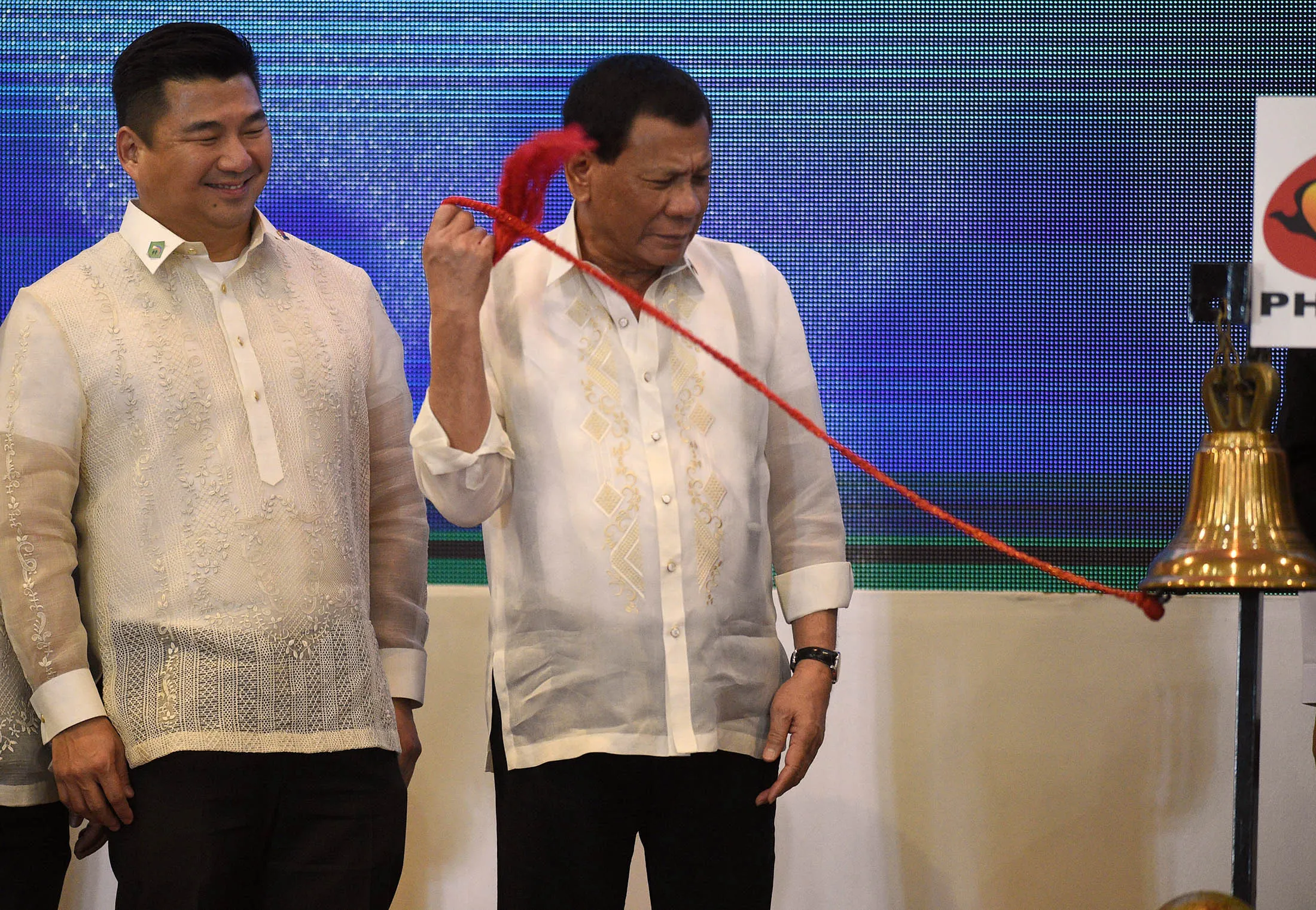 Uy, left, with Rodrigo Duterte at the Philippine Stock Exchange in Manila in 2017.