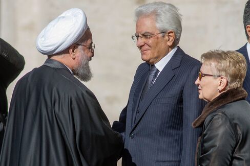 Italy’s president Sergio Mattarella, second right, greets Hassan Rouhani in Rome.