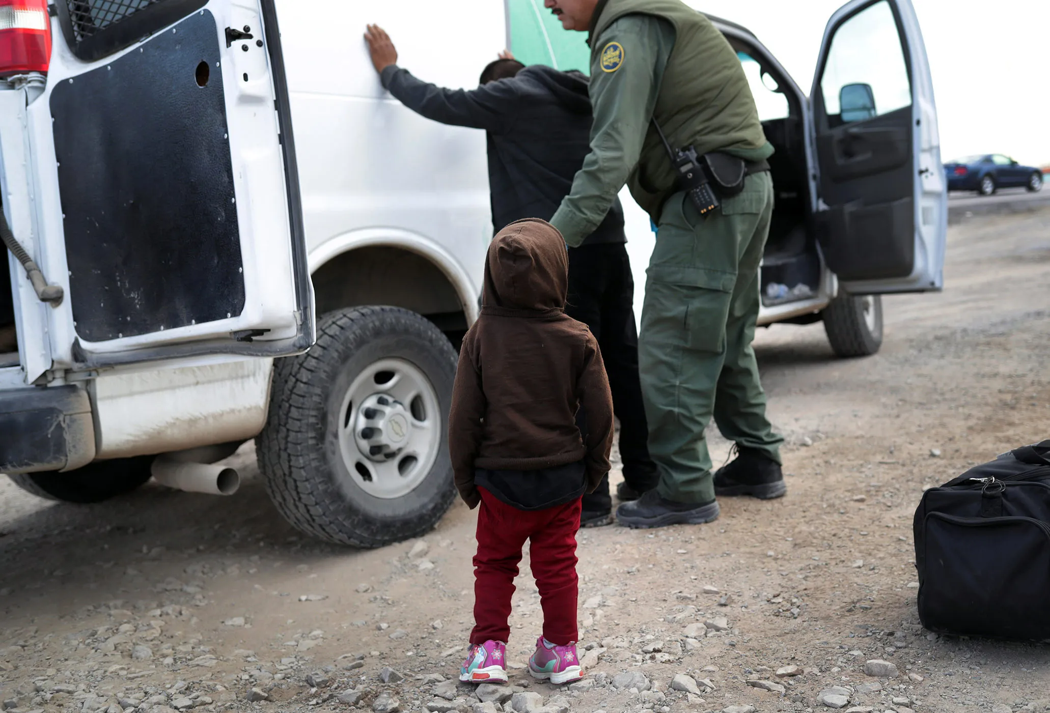 A U.S. Border Patrol agent conducts a search in El Paso, Texas.
