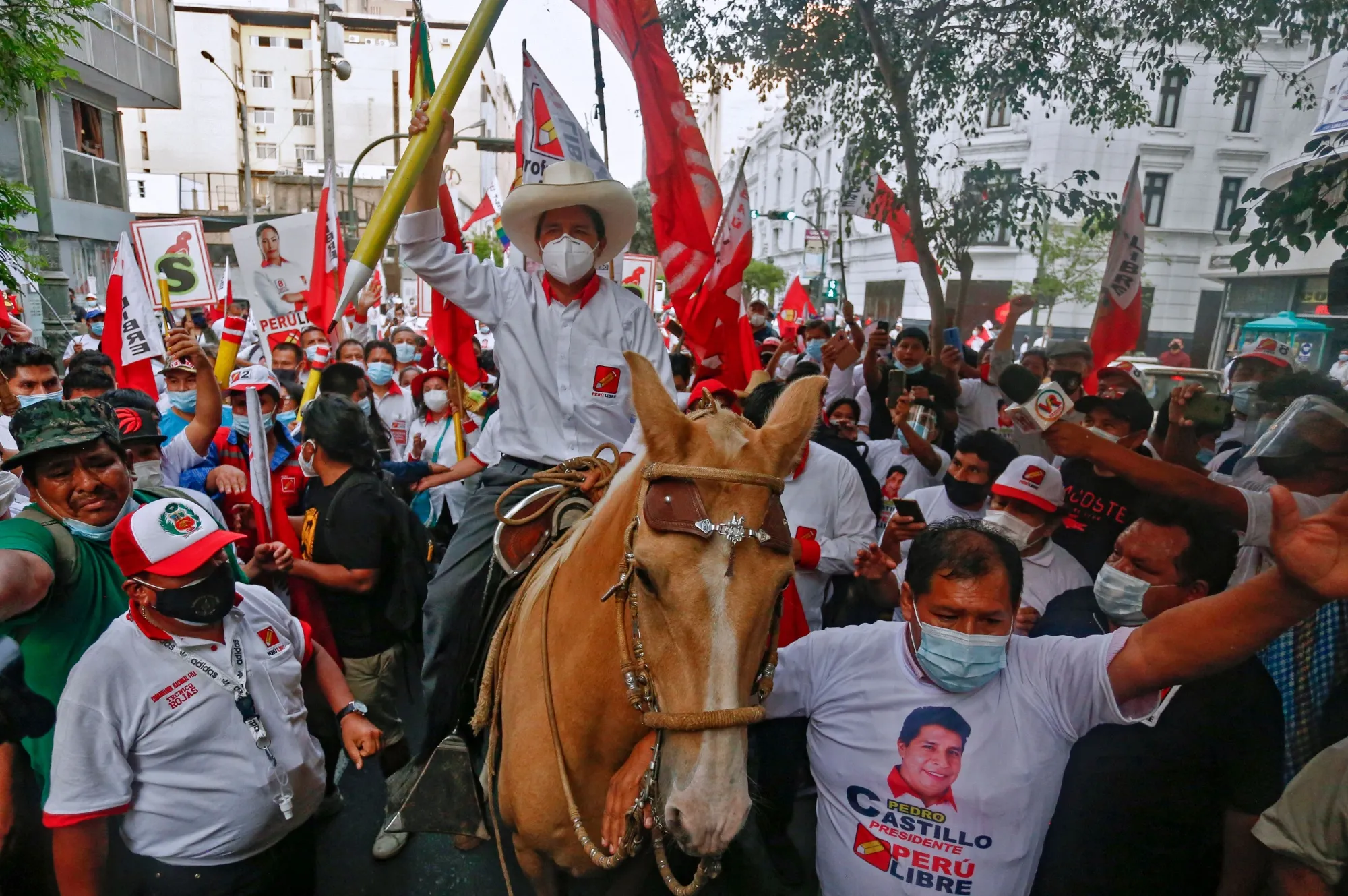 Pedro Castillo rides a horse holding a giant pencil during the closing rally of his campaign in Lima on April 8, 2021.