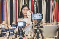 young woman Asian selling shoes online by live streaming, Young female vlogger recording content for her online fashion channel on social media,