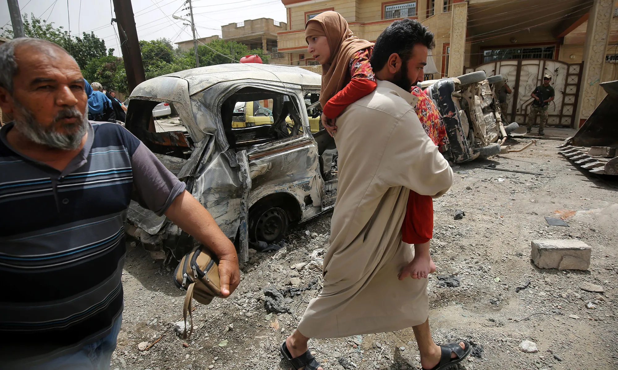 Residents flee their neighborhood as Iraqi forces continue their military offensive to retake Mosul from the Islamic State on May 19, 2017.
