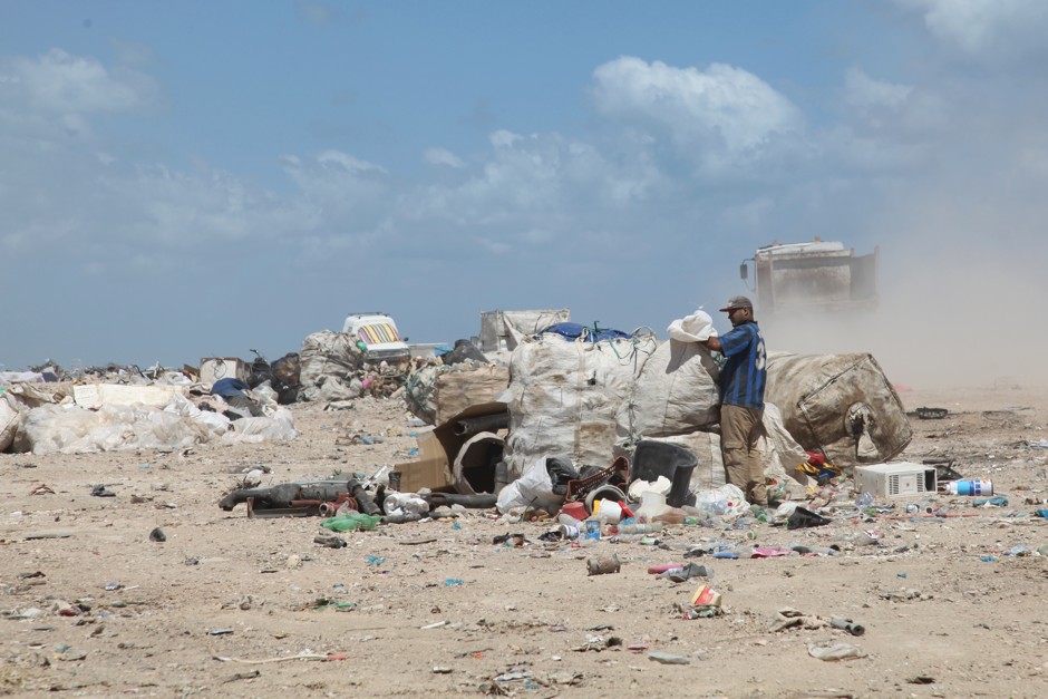 Collecting plastic, glass, and paper from a sand-covered landfill in Gammarth, a suburb of Tunis.