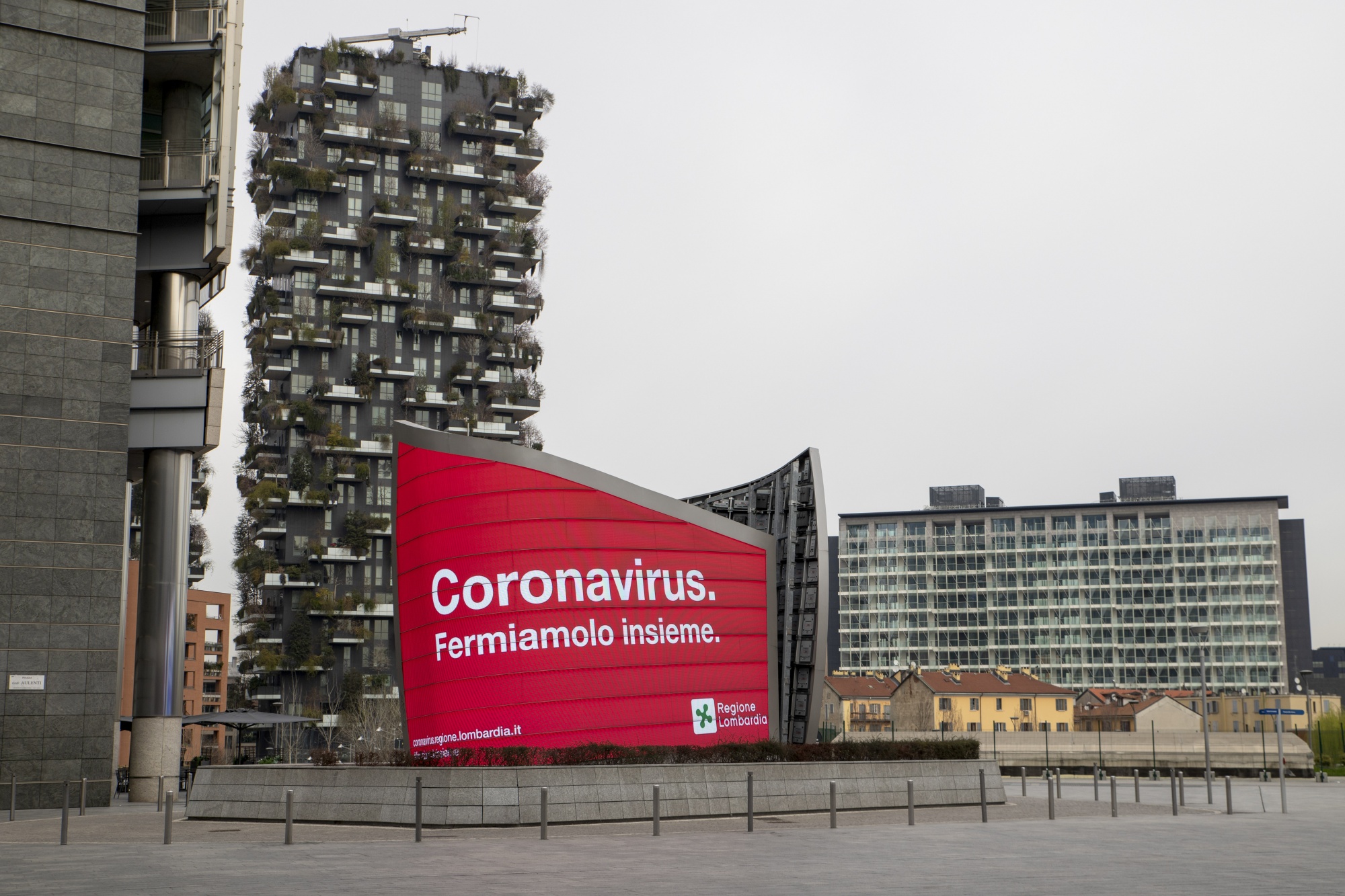 A regional government notice reading &quot;Cornonavirus, Let's stop it together,&quot; sits on display by residnetial apartments in Milan, on March 10.