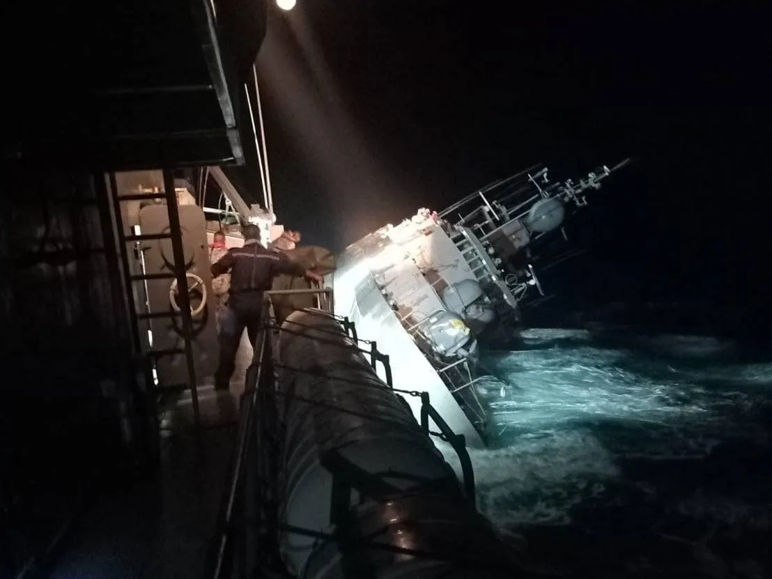 The HTMS Sukhothai vessel tilts prior to sinking on Dec. 19.