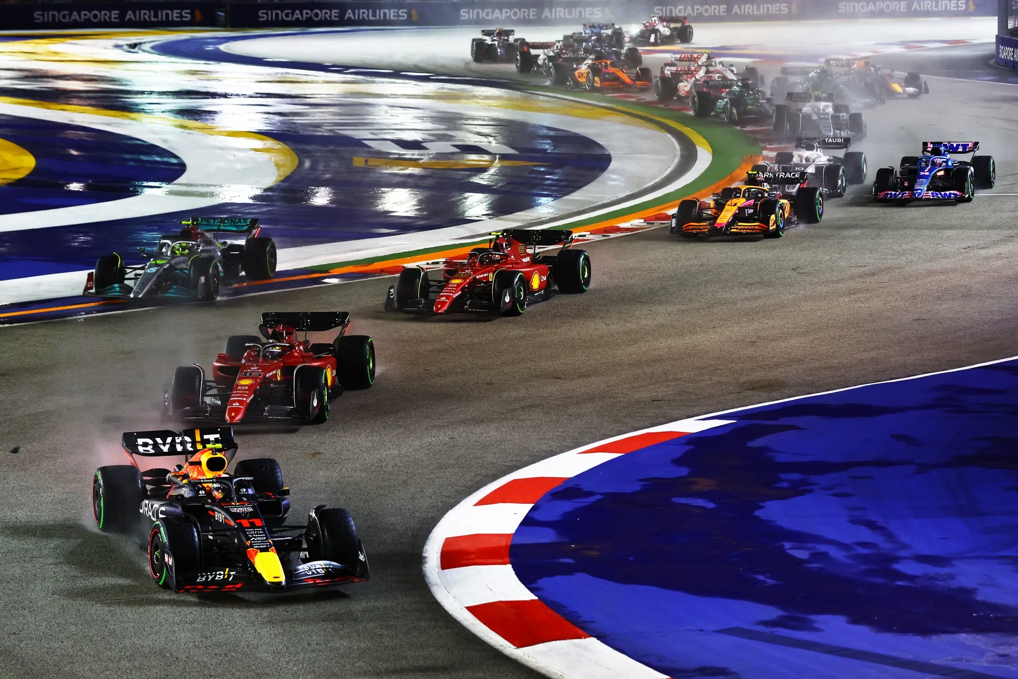 Sergio Perez driving the Oracle Red Bull Racing RB18 leads the rest of the field during the F1 Grand Prix of Singapore in 2022.