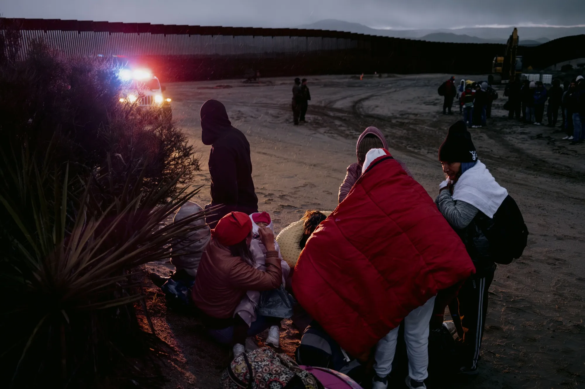 Migrants wait to be transported for asylum claim processing at the US-Mexico border in Campo, California,&nbsp;on&nbsp;April 5, 2024.