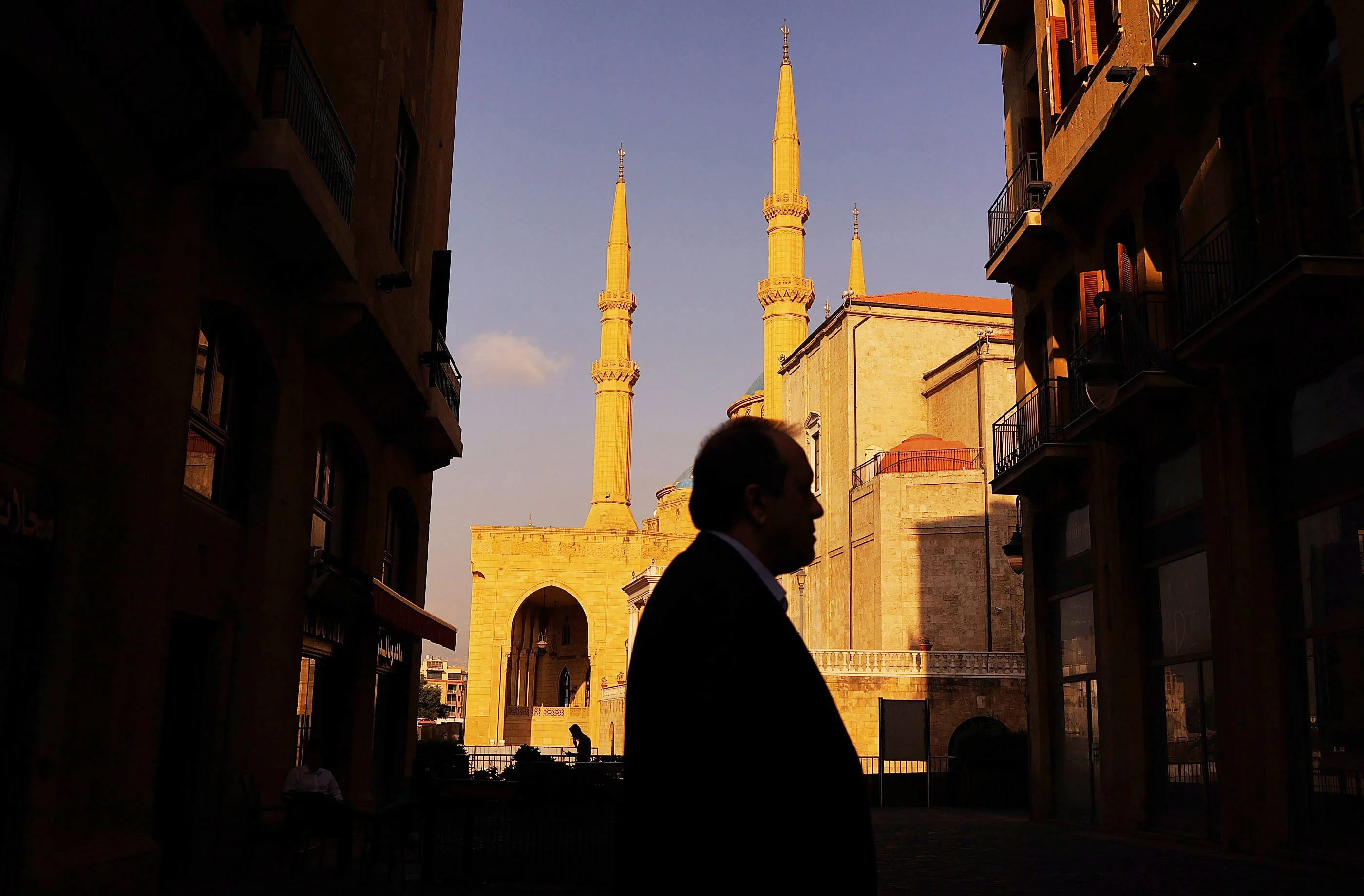 A man walks in front of a mosque in Beirut.