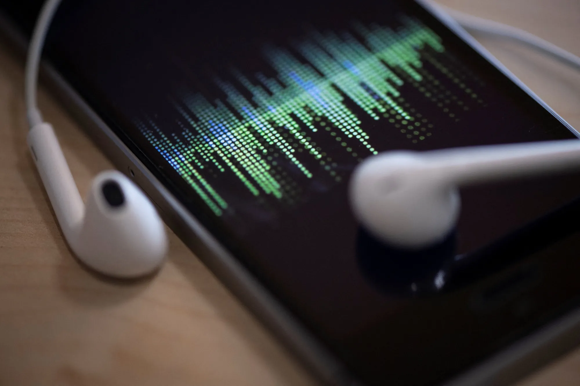 A picture taken&nbsp;in Paris shows a smartphone and its earphones as an audio podcast is being played