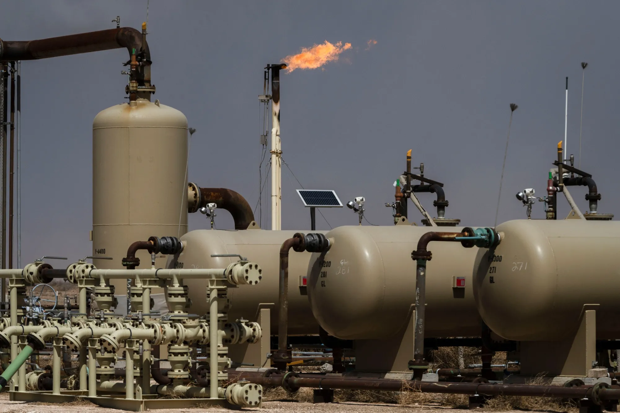 Flares burn off excess natural gas at an oil and gas well&nbsp;near Tarzan, Texas.