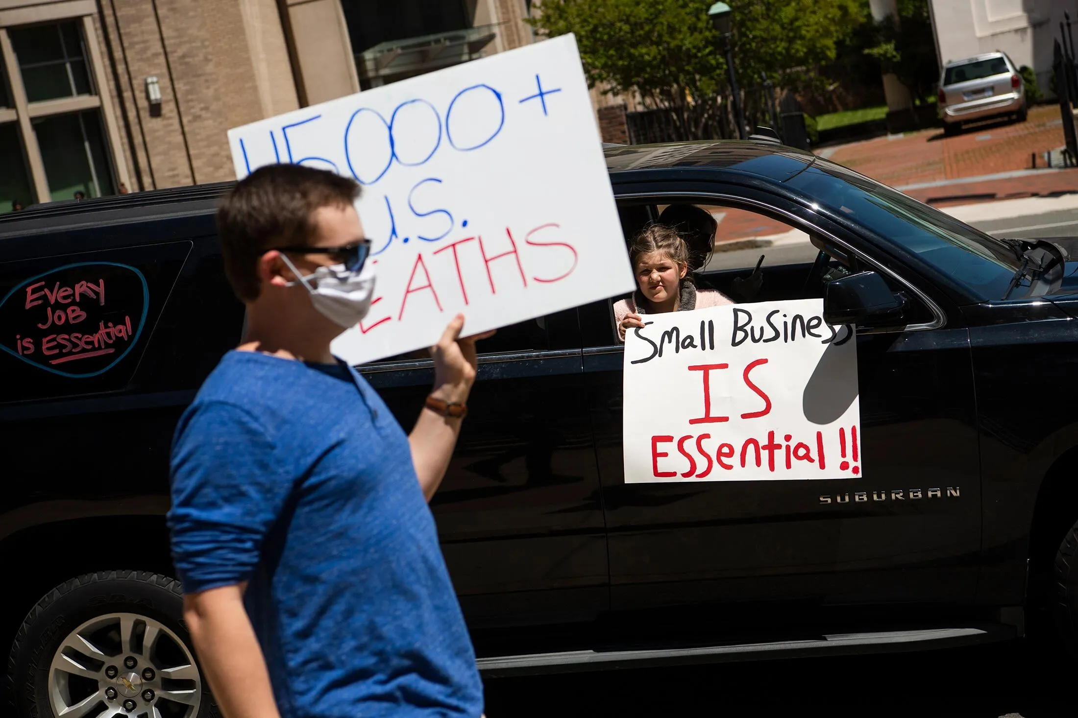 A counterprotester (left) is seen near Capitol Square in Richmond, Va., during an&nbsp;April 22 rally to demand that Governor Ralph Northam lift restrictions that have closed certain businesses amid the coronavirus outbreak.