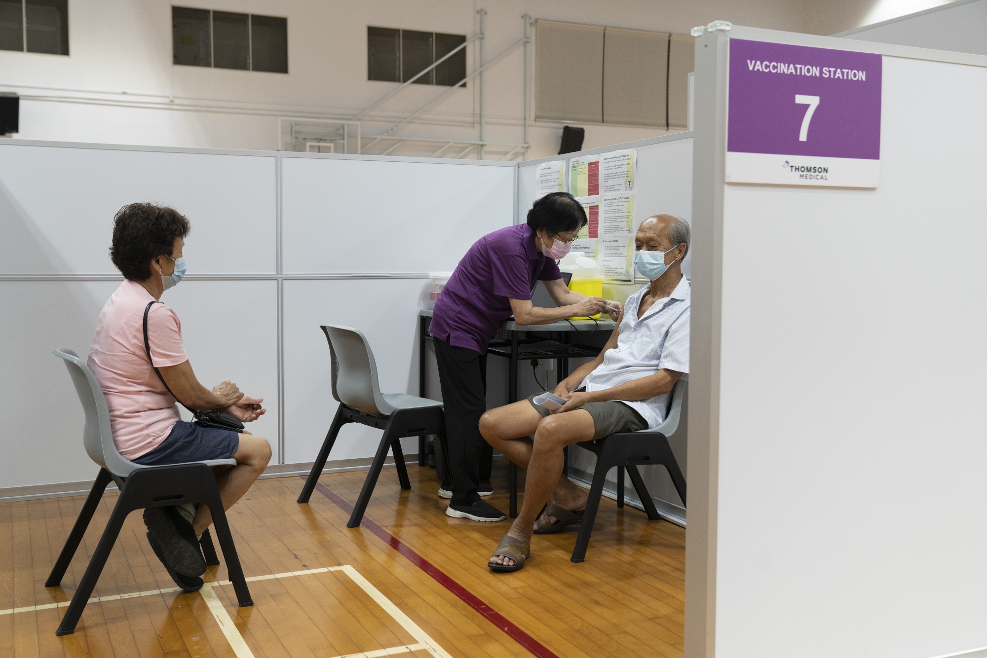 A health worker administers the Covid-19 vaccine&nbsp;in Singapore.