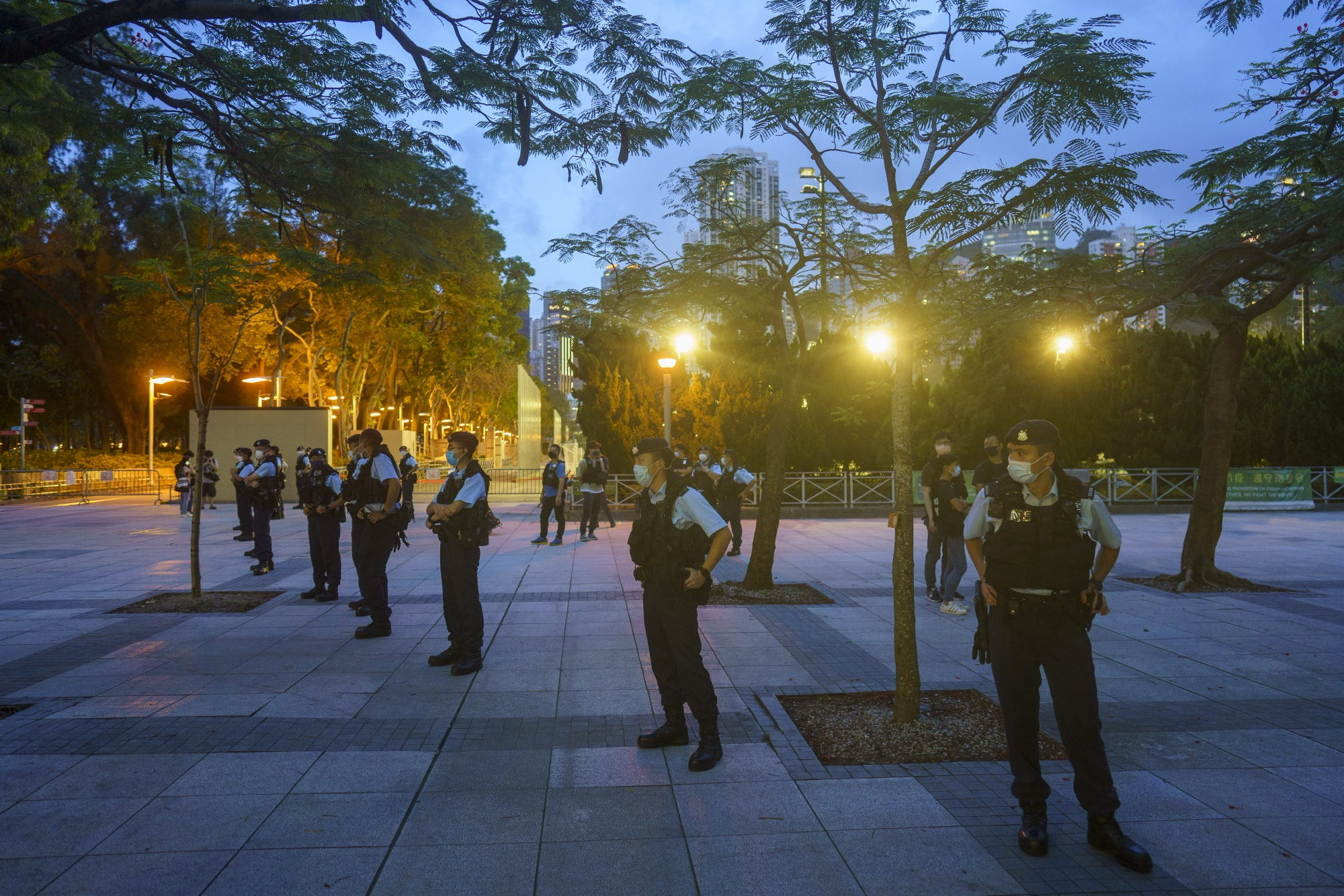 Police officers stand guard at Victoria Park, the traditional site of the annual Tiananmen candlelight vigil, on June 4.