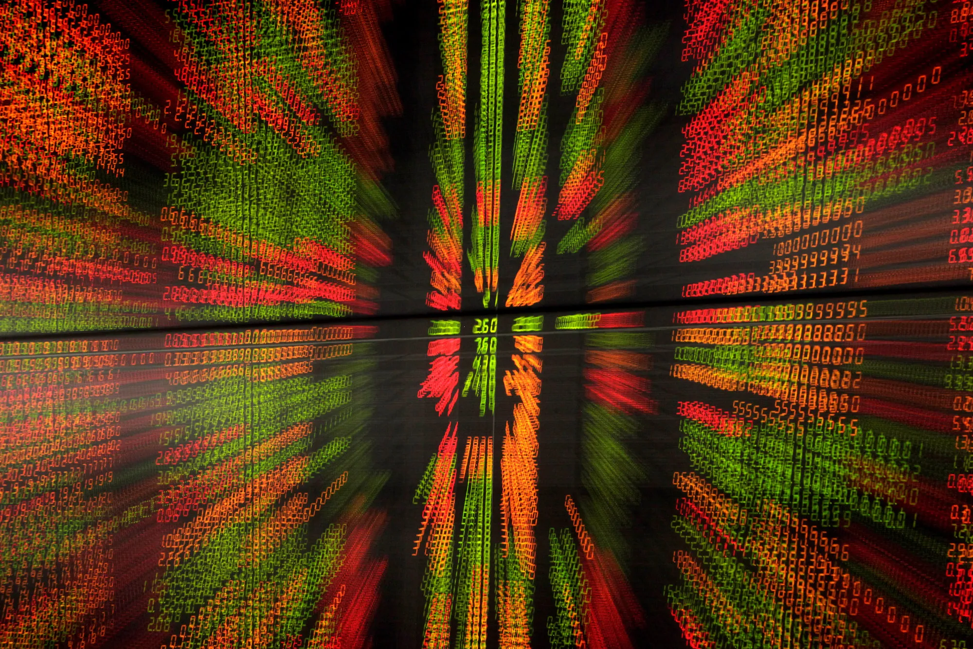Stocks prices displayed on an electronic stock board are photographed with a zoom effect in Thailand.