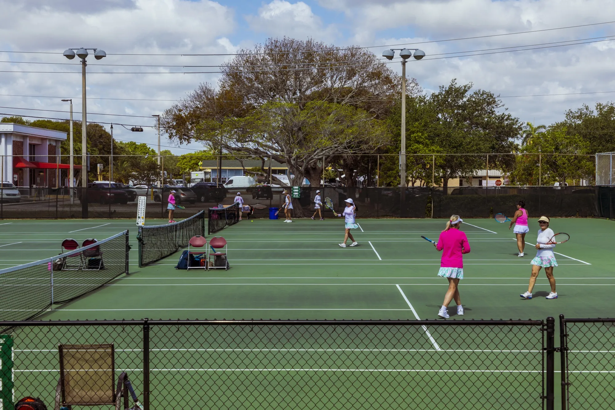 People playing tennis at South Olive Park in the South of Southern (SoSo) residential area of West Palm Beach, Florida.