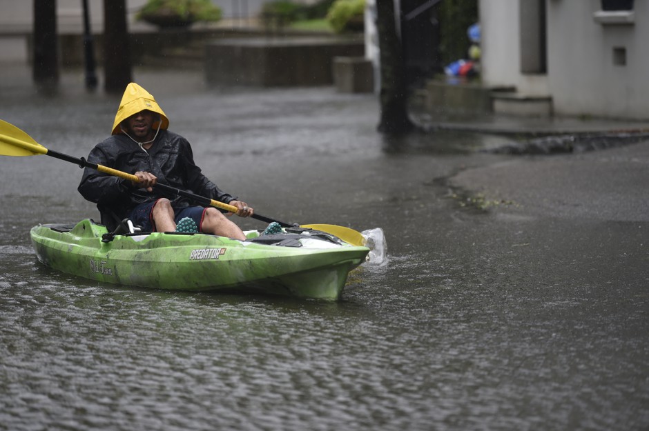 A man navigates his kayak down a flooded street in Charleston following Hurricane Dorian.