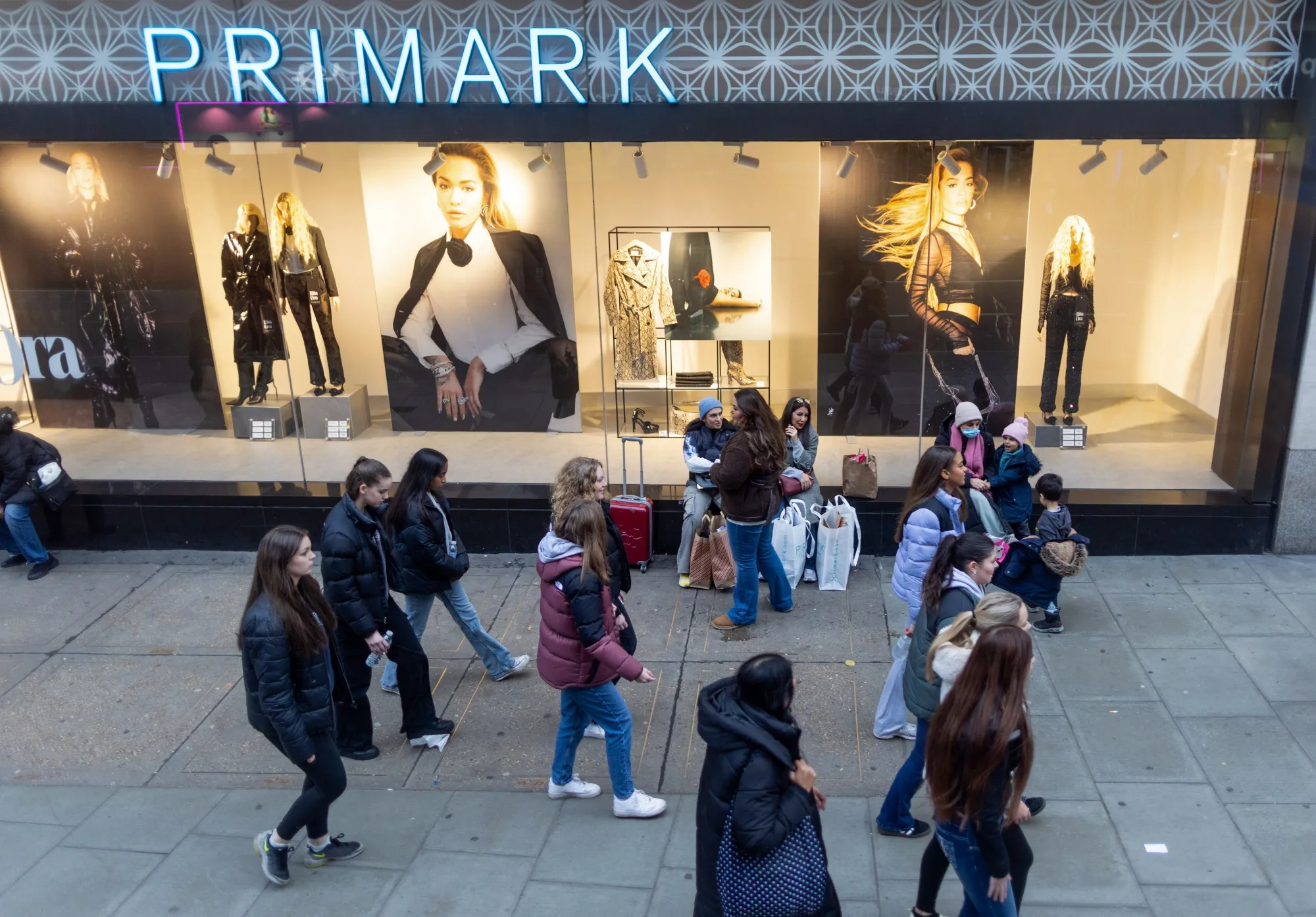 Shoppers pass a Primark store in London in December 2023.