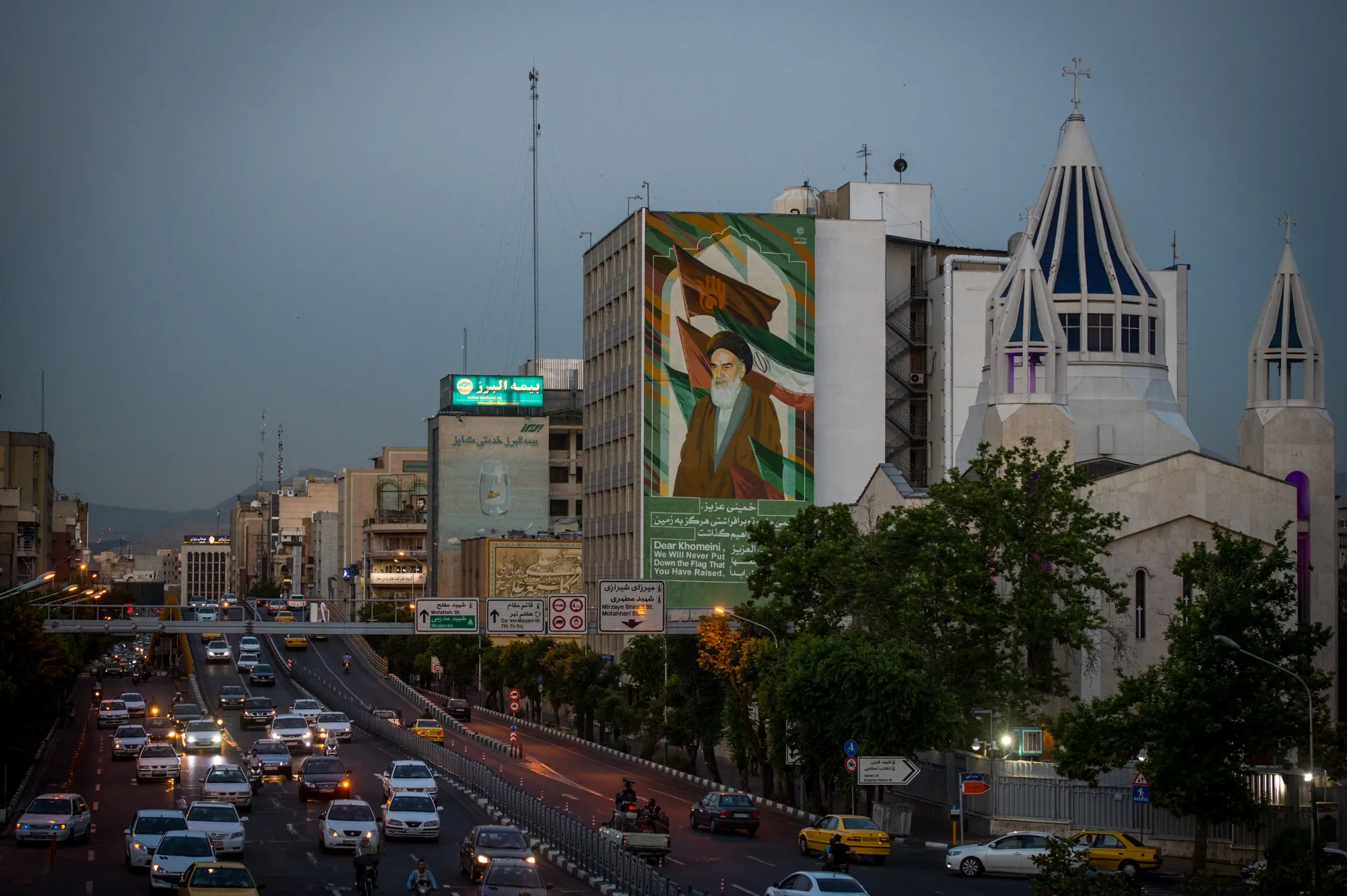 A mural depicting Ruhollah Khomeini, founder of the Islamic republic of Iran, stands above a roadside&nbsp;in Tehran.