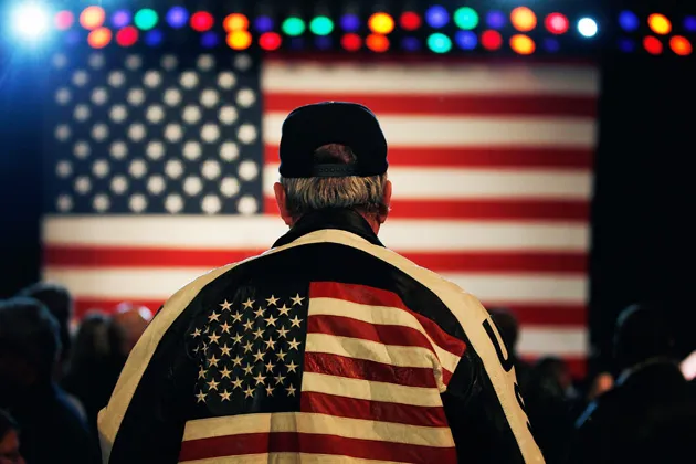 A supporter of Republican presidential candidate Mitt Romney watches during a campaign event at the Royal Oak Music Theatre in Royal Oak, Mich.