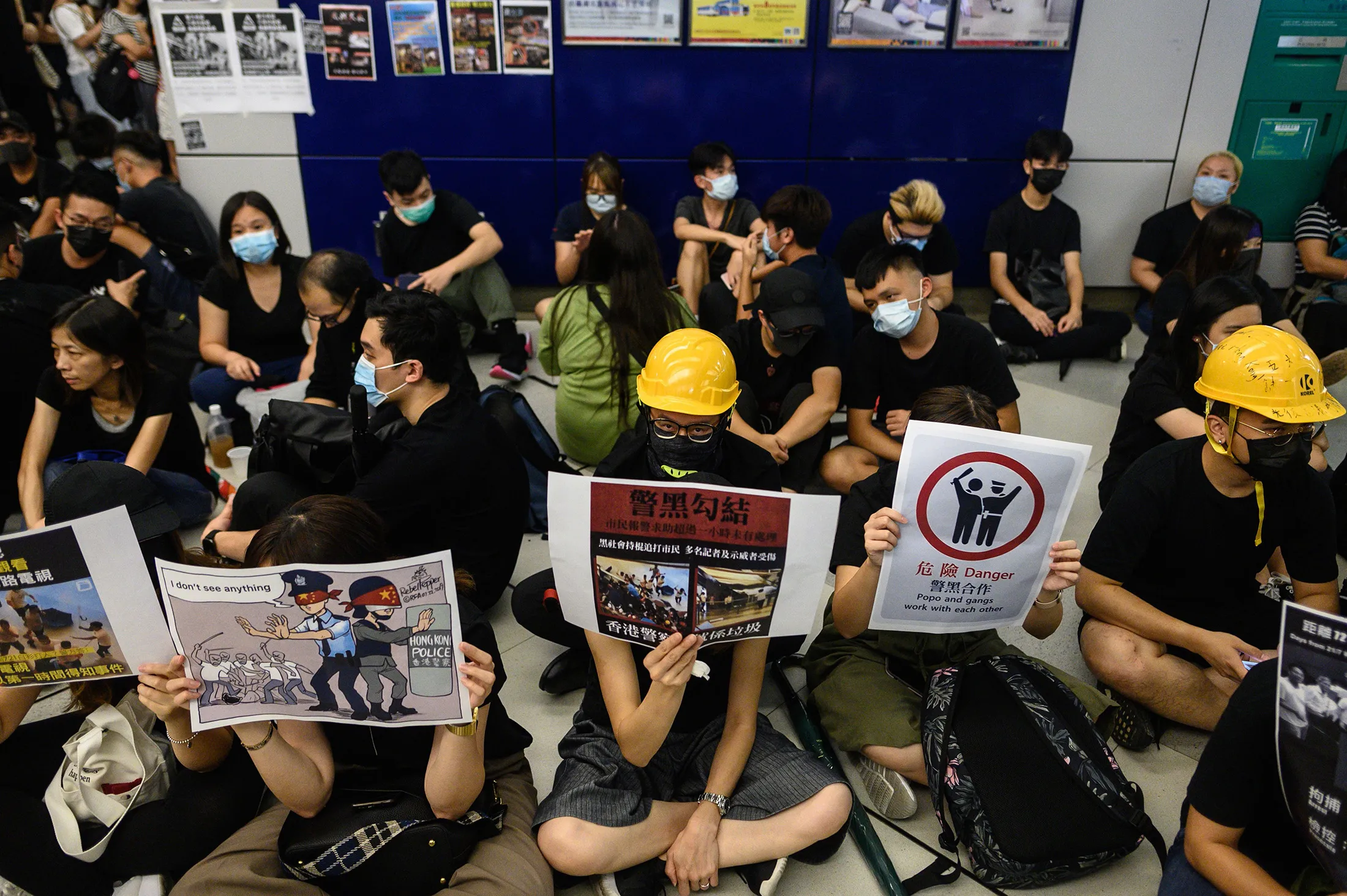 Protesters take part in a silent rally at Yuen Long MTR station in Hong Kong on Aug. 21.
