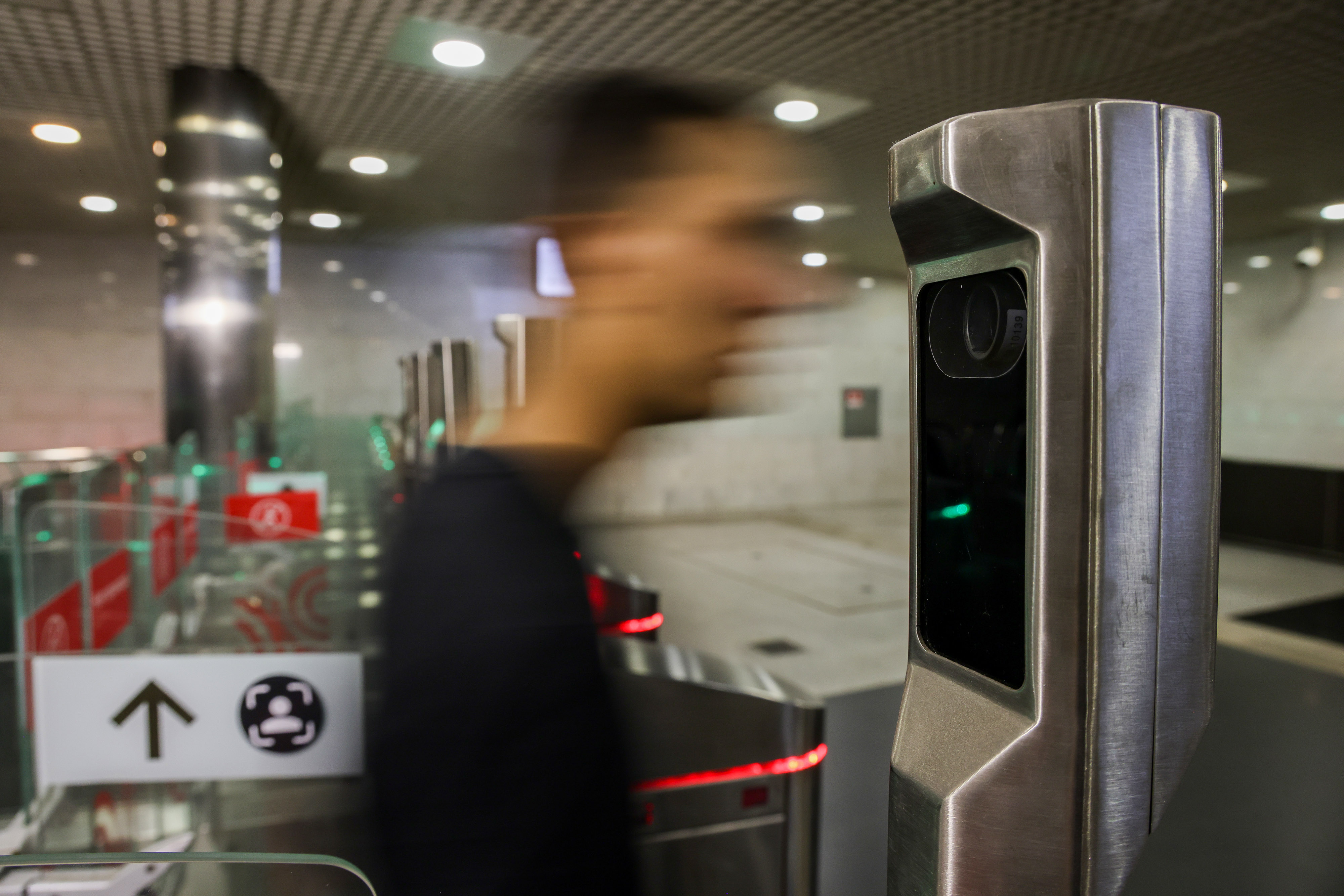 A traveler walks through facial recognition payment gates in Moscow.