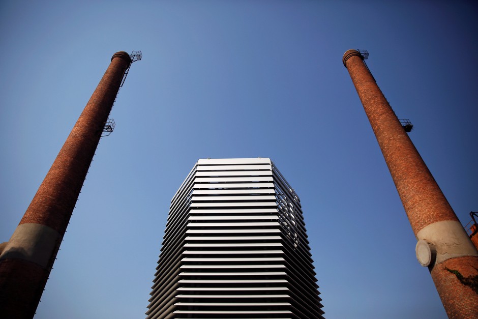 The Smog Free Tower is flanked by old smokestacks in Beijing.