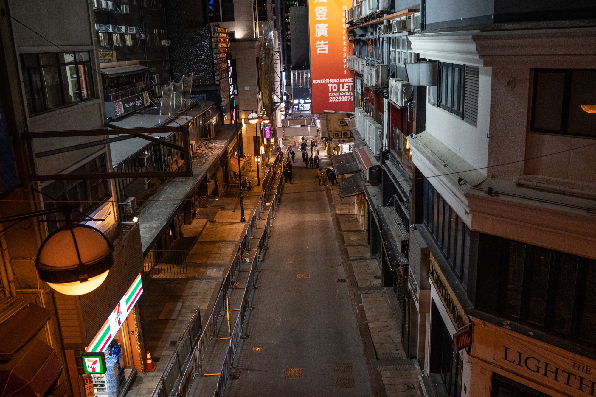 Closed bars line a street at Lan Kwai Fong in Hong Kong in December. New rules will allow bars and nightclubs to remain open until 2 a.m.