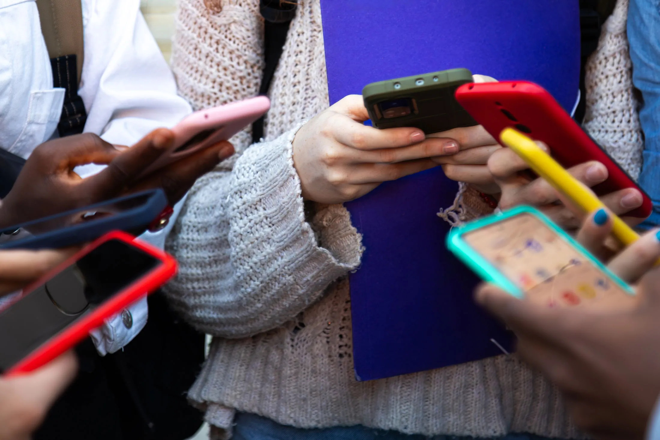Teenagers using mobile phones.