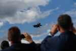 Attendees take photographs of the Lockheed Martin Corp. F-35 at the Farnborough International Airshow.