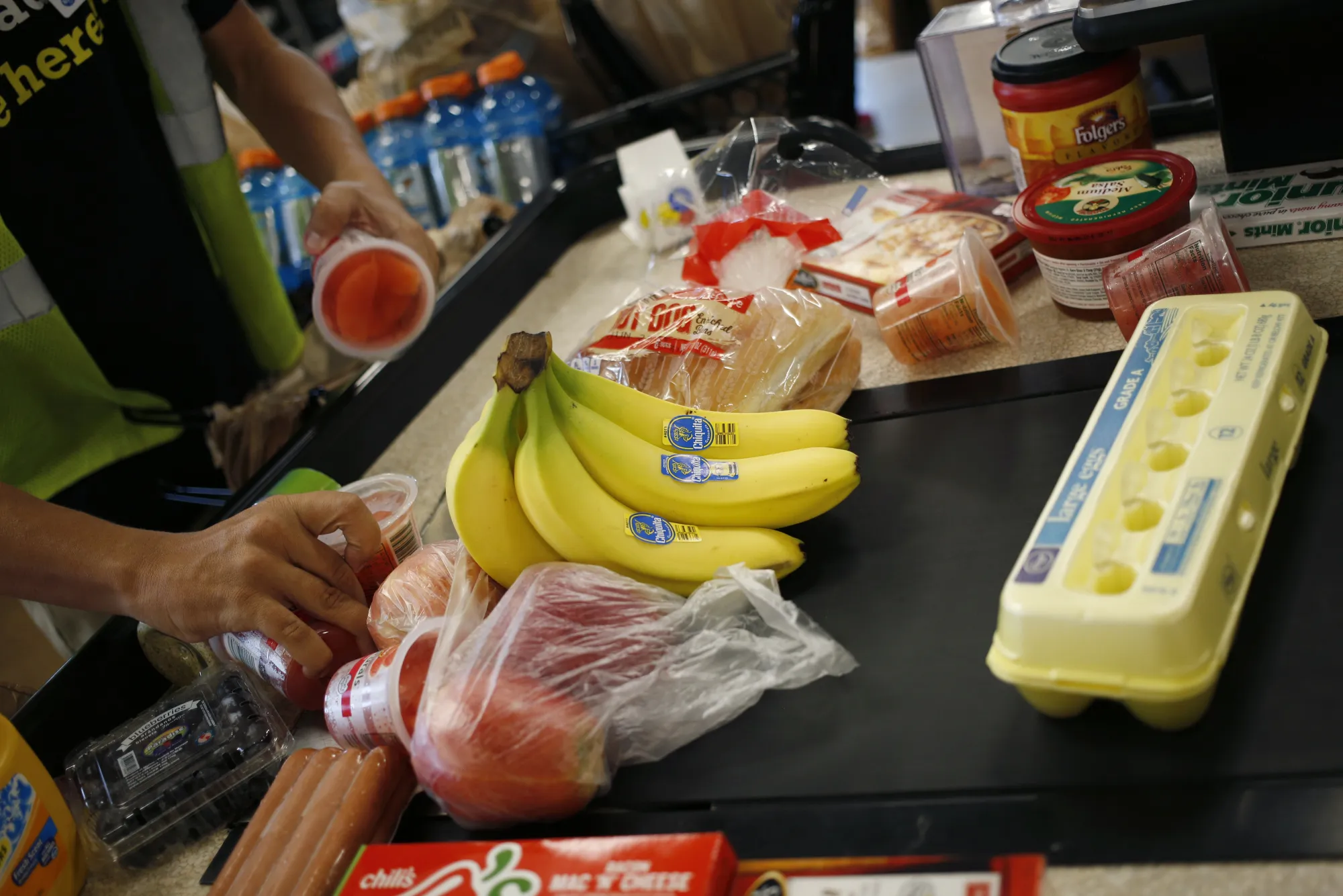 An employee bags groceries for a customer at a checkout counter inside a Kroger Co. grocery store in Louisville, Kentucky, U.S., on Wednesday, June 14, 2017.&nbsp;