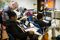 Spanish social studies teacher Jorge Cabanas, left, helps his students as they use their Amplify tablets during a class exercise at Aycock Middle School.